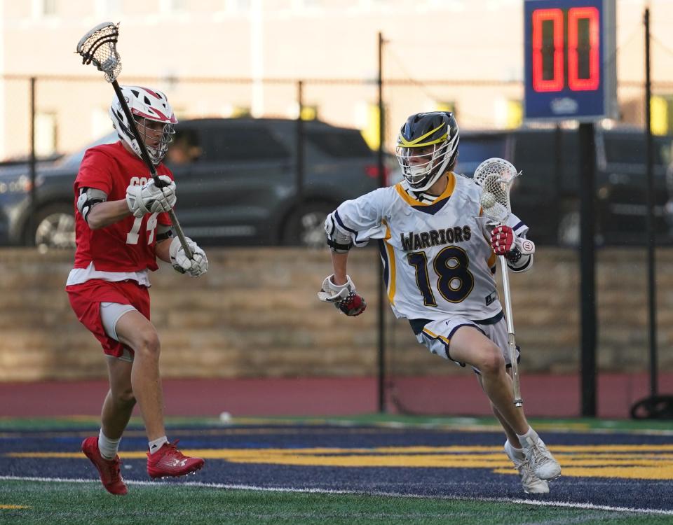 Lourdes' Drew Cornax (18) works the ball during their 16-15 win over Goshen in boys lacrosse action Our Lady of Lourdes High School in Poughkeepsie on Friday, May 5, 2023. 