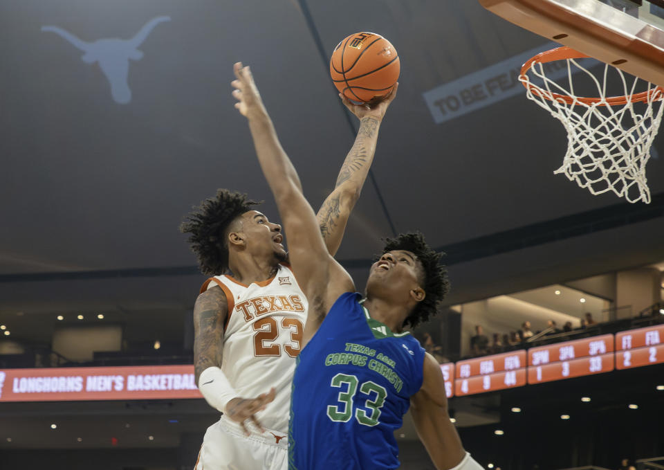 Texas forward Dillon Mitchell (23) goes up for a shot against Texas A&M Corpus Christi forward Gary Clark (33) during the first half of an NCAA college basketball game, Friday, Dec. 22, 2023, in Austin, Texas. (AP Photo/Michael Thomas)