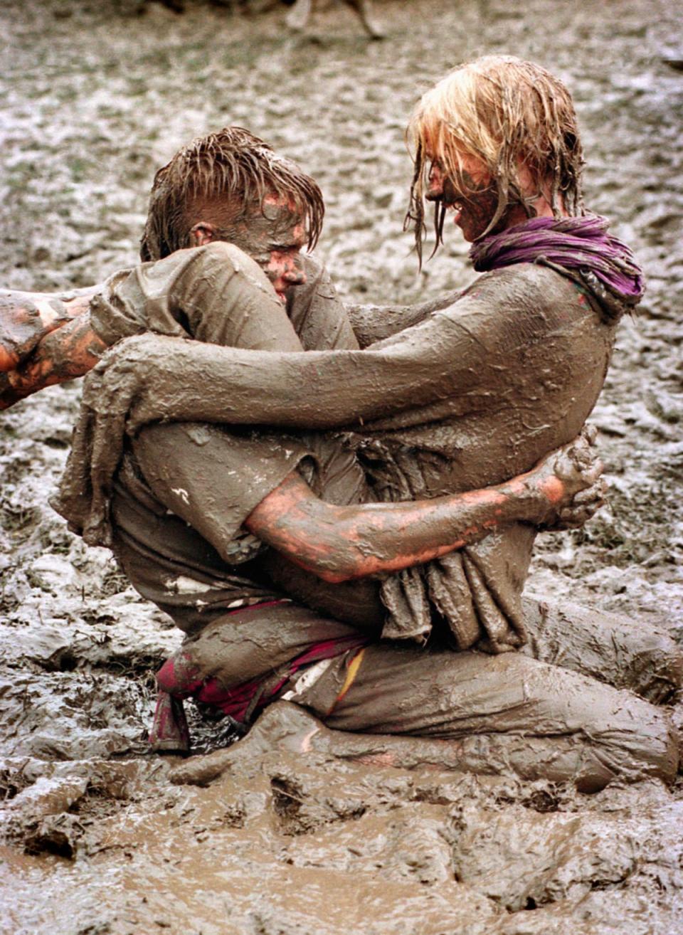 Music fans enjoy the mud pools at the 1997 Glastonbury festival (Martin Bennett/PA) (PA Archive)