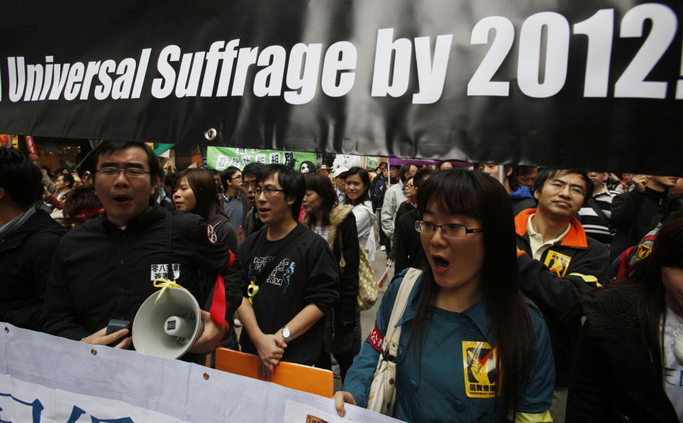 FILE - In this file photo taken Friday, Jan. 1, 2010, pro-democracy protesters march to China's Liaison Office demanding universal suffrage by year 2012 and the release mainland dissident Liu Xiaobo in Hong Kong. The Basic Law states that its ultimate aim is for Hong Kong voters to directly elect their chief executive and lawmakers, but China decided in 2007 that universal suffrage in the chief executive election could not be implemented until 2017. (AP Photo/Kin Cheung, File)