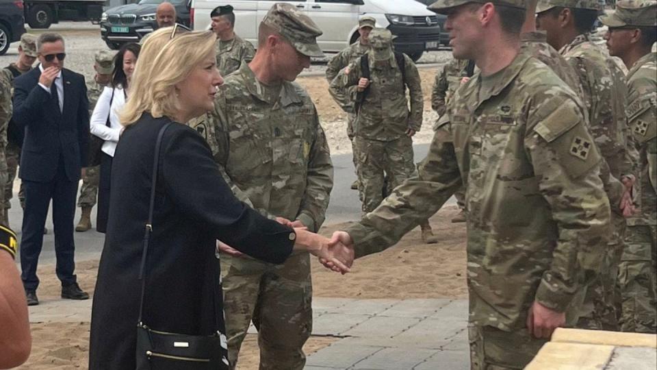 Sgt. Collin Pattan (R) shakes hands with Army Secretary Christine Wormuth (L) in Lithuania during June 2022. (Courtesy of Collin Pattan)