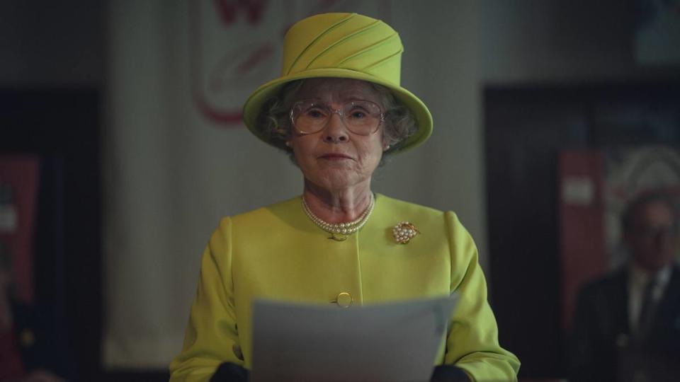 Woman holding paper to read The Crown Final Season part 2