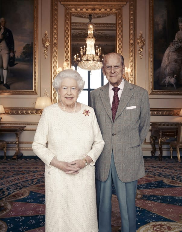 In this photograph released by Buckingham Palace, taken by Camera Press photographer Matt Holyoak this month, Britain's Queen Elizabeth II and her husband, Britain's Prince Philip, Duke of Edinburgh pose in the White Drawing Room at Windsor Castle, to mark their 70th Wedding Anniversary