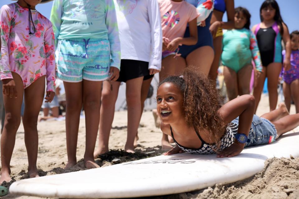 Mila Jituboh takes tips from an instructor on how to surf at First Point in Malibu.