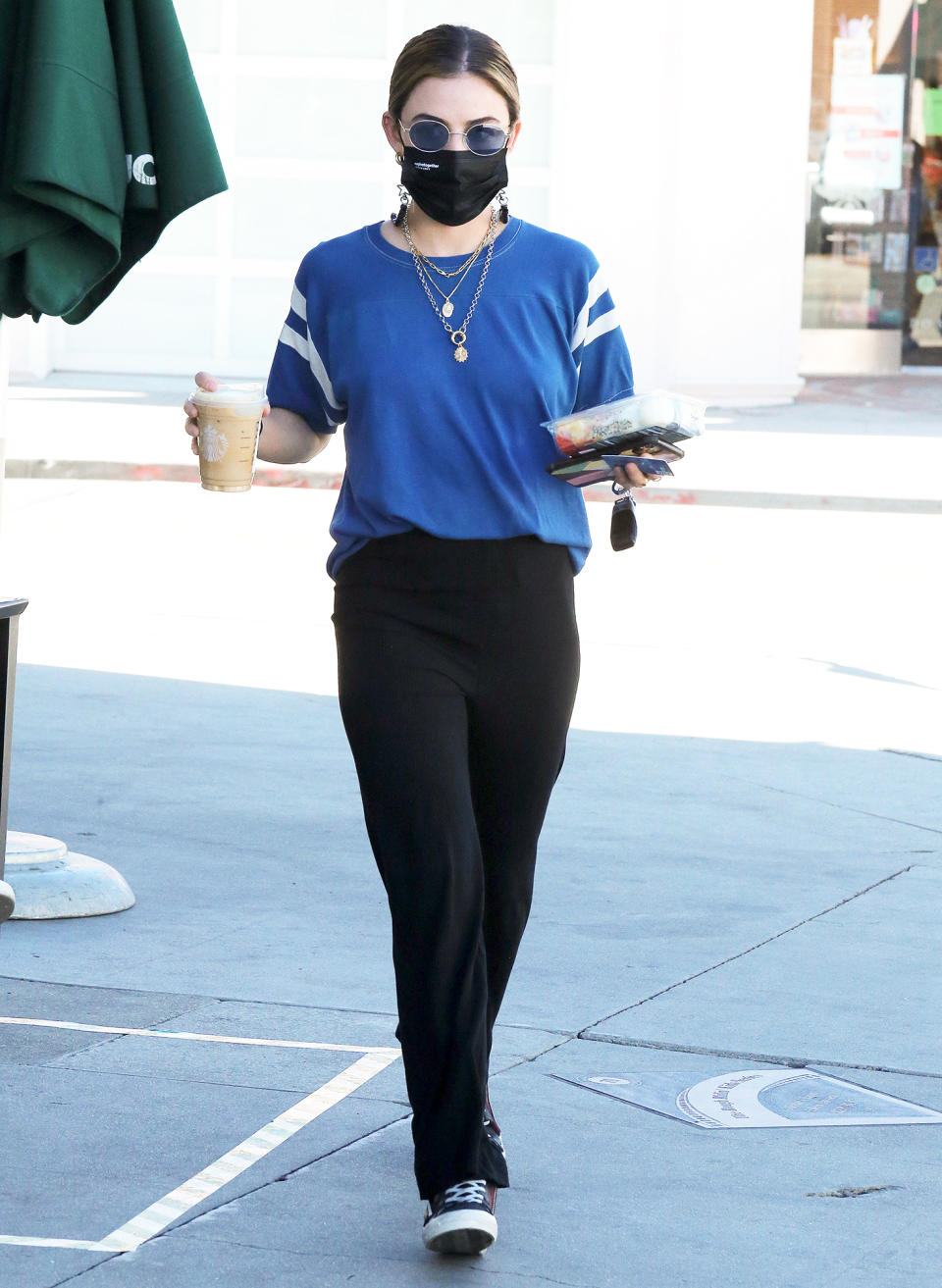 <p>Lucy Hale is spotted in L.A. on Monday grabbing her Starbucks to go in a comfy tee and gold jewelry. </p>