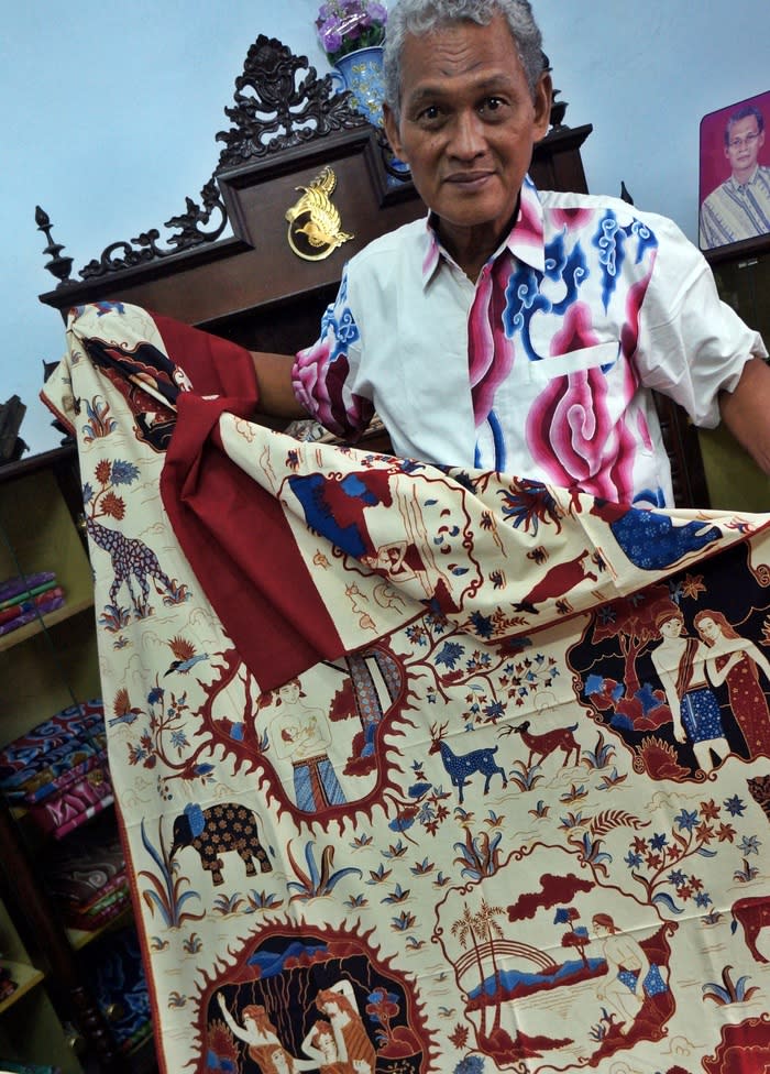 Showing off: Batik artist Katura shows his batik creation. The Cirebon batik's base color of Cirebon batik is usually of the lighter shades. (