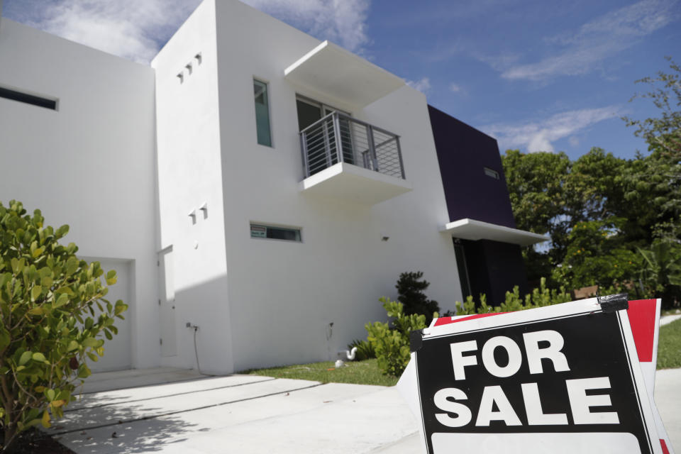 A for-sale sign is posted in front of a home in Miami in this 2019 photo. The average rate on a 30-year mortgage edged up to just below 7%.