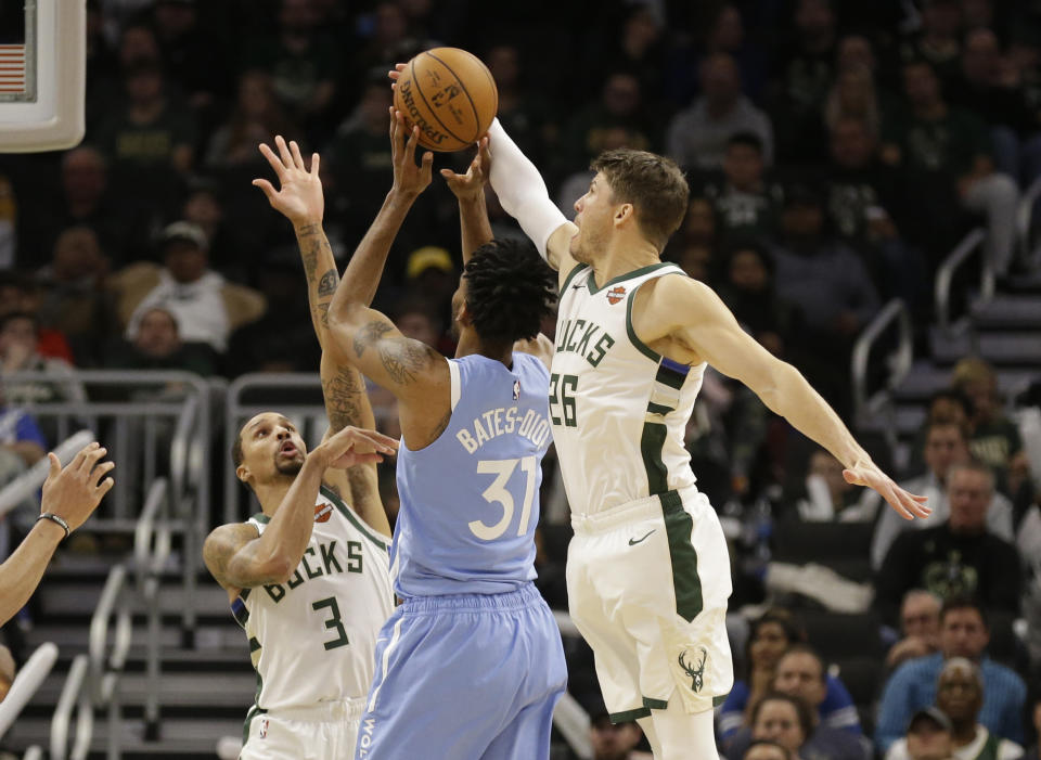 Milwaukee Bucks' Kyle Korver (26) blocks the shot of Minnesota Timberwolves' Keita Bates-Diop during the second half of an NBA basketball game Wednesday, Jan. 1, 2020, in Milwaukee. The Bucks won 106-104.(AP Photo/Jeffrey Phelps)