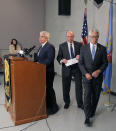 U.S. Attorney Berry Grissom, right, and Johnson County District Attorney Steve Howe, center, depart as public information officer Gary Mason, left, ends a news conference in Overland Park, Kan., Tuesday, April 15, 2014. Kansas prosecutors filed state-level murder charges Tuesday against white supremacist, Frazier Glenn Cross, who is accused in a shootings that left three people dead at two Jewish community sites in suburban Kansas City on Sunday. (AP Photo/Orlin Wagner)