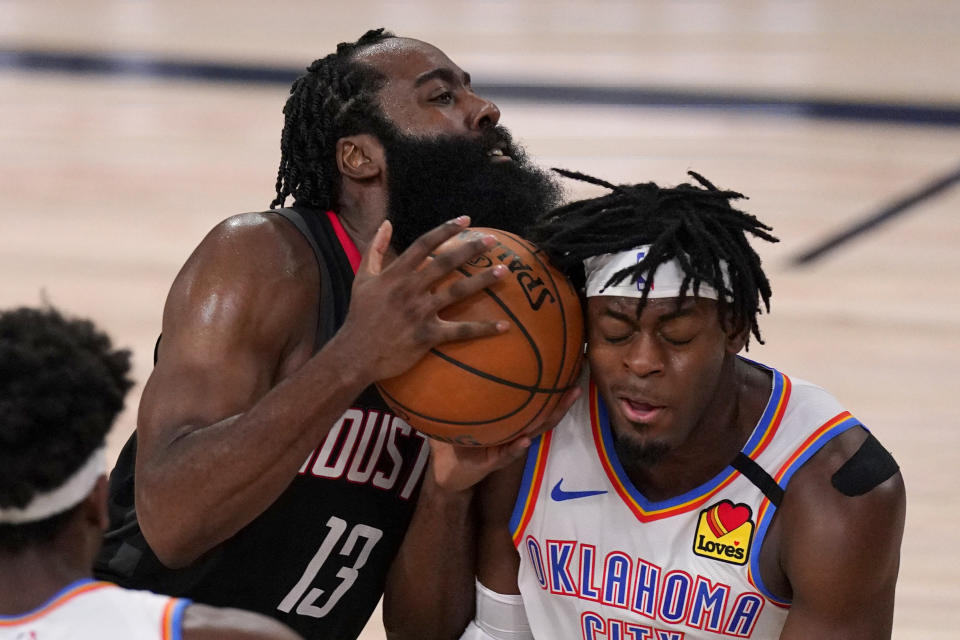 Houston Rockets' James Harden (13) drives into Oklahoma City Thunder's Luguentz Dort (5), right, trying to get up court during the second half of an NBA first-round playoff basketball game in Lake Buena Vista, Fla., Wednesday, Sept. 2, 2020. (AP Photo/Mark J. Terrill)