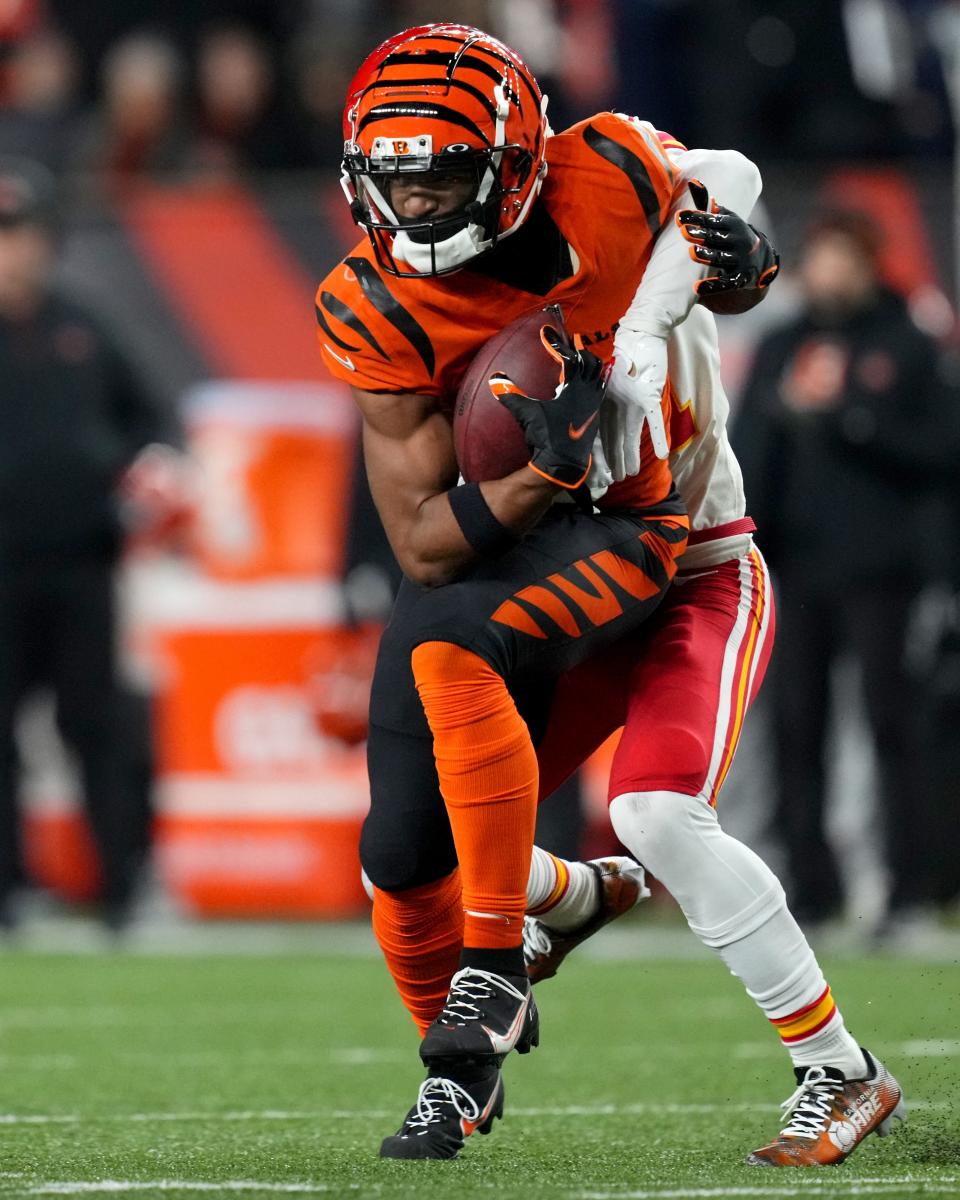 Cincinnati Bengals wide receiver Ja'Marr Chase (1) catches a pass as Kansas City Chiefs cornerback Trent McDuffie (21) defends in the fourth quarter of a Week 13 NFL game, Sunday, Dec. 4, 2022, at Paycor Stadium in Cincinnati. Mandatory Credit: Kareem Elgazzar-The-Cincinnati Enquirer-USA TODAY Sports