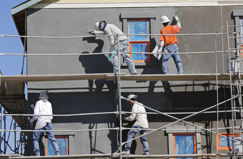 OCTOBER 31, 2013. IRVINE, CA. A team of masons put the finish coat of stucco on a two-story house in the Pavillion Park neighborhood of new homes in the Great Park, Irvine, CA. (Don Bartletti / Los Angeles Times)