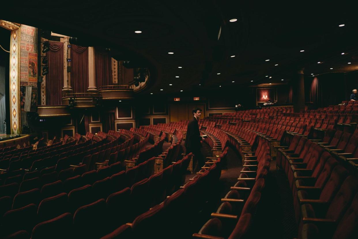 a person standing in a large theater