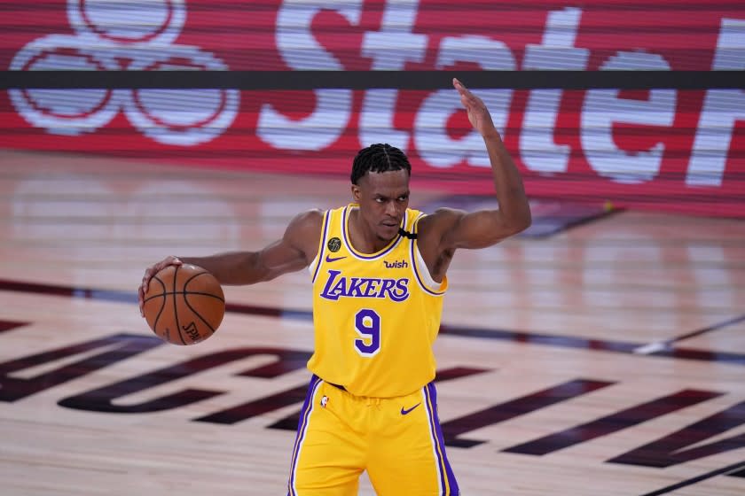 Los Angeles Lakers' Rajon Rondo (9) signals to teammates during an offensive possession in the second half an NBA conference final playoff basketball game against the Denver Nuggets on Friday, Sept. 18, 2020, in Lake Buena Vista, Fla. (AP Photo/Mark J. Terrill)