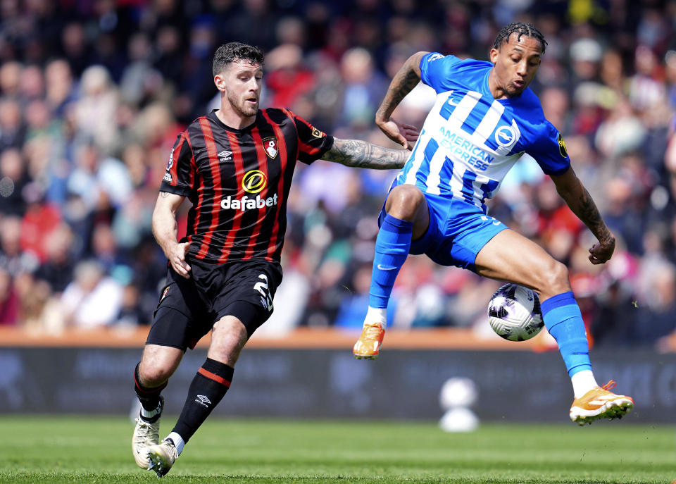 Bournemouth's Marcos Senesi, left, and Brighton and Hove Albion's Joao Pedro , right, challenge for the ball during the English Premier League soccer match between AFC Bournemouth and Brighton & Hove Albion in Bournemouth, England, Sunday, April 28, 2024. (Adam Davy/PA via AP)