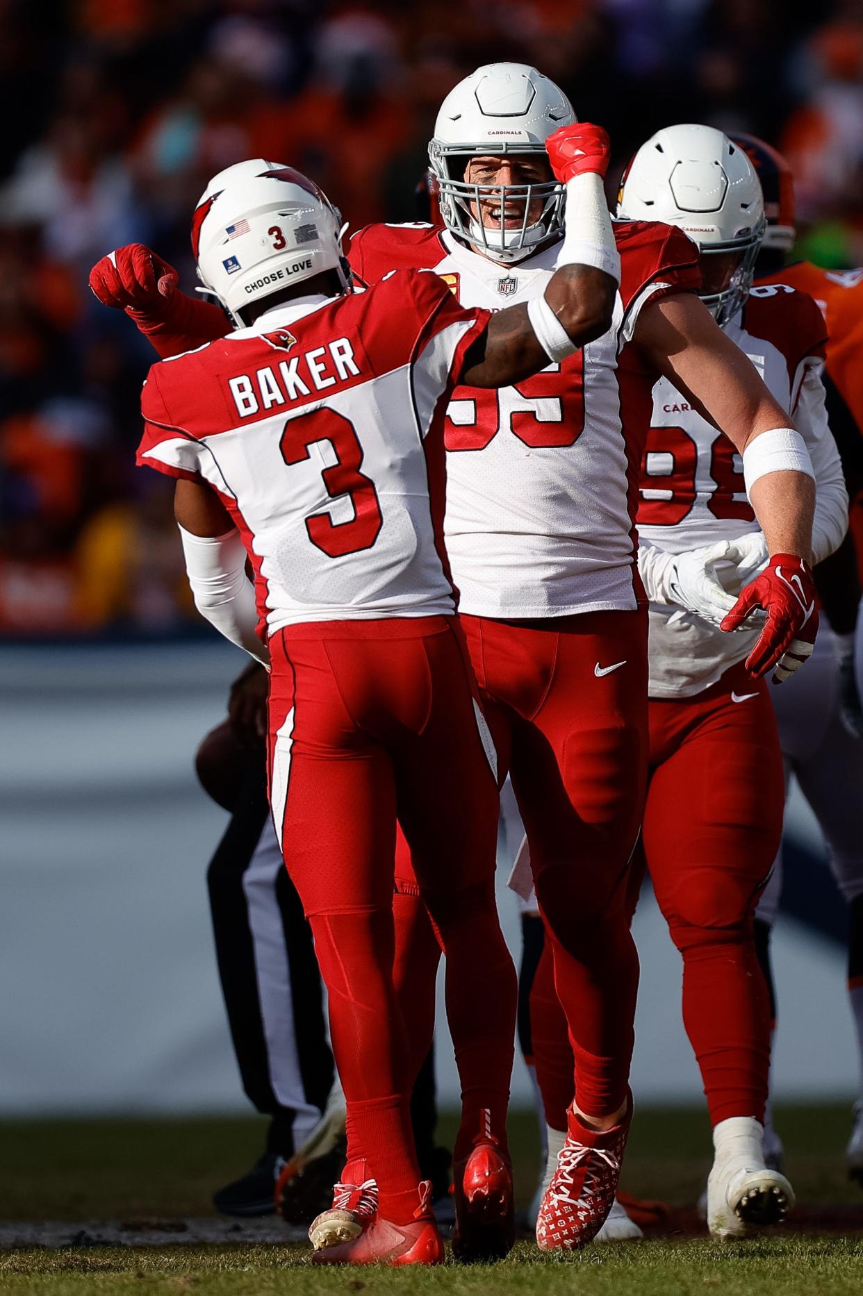 Dec 18, 2022; Denver, Colorado, USA; Arizona Cardinals defensive end J.J. Watt (99) celebrates his sack with safety Budda Baker (3) in the first quarter against the Denver Broncos at Empower Field at Mile High.