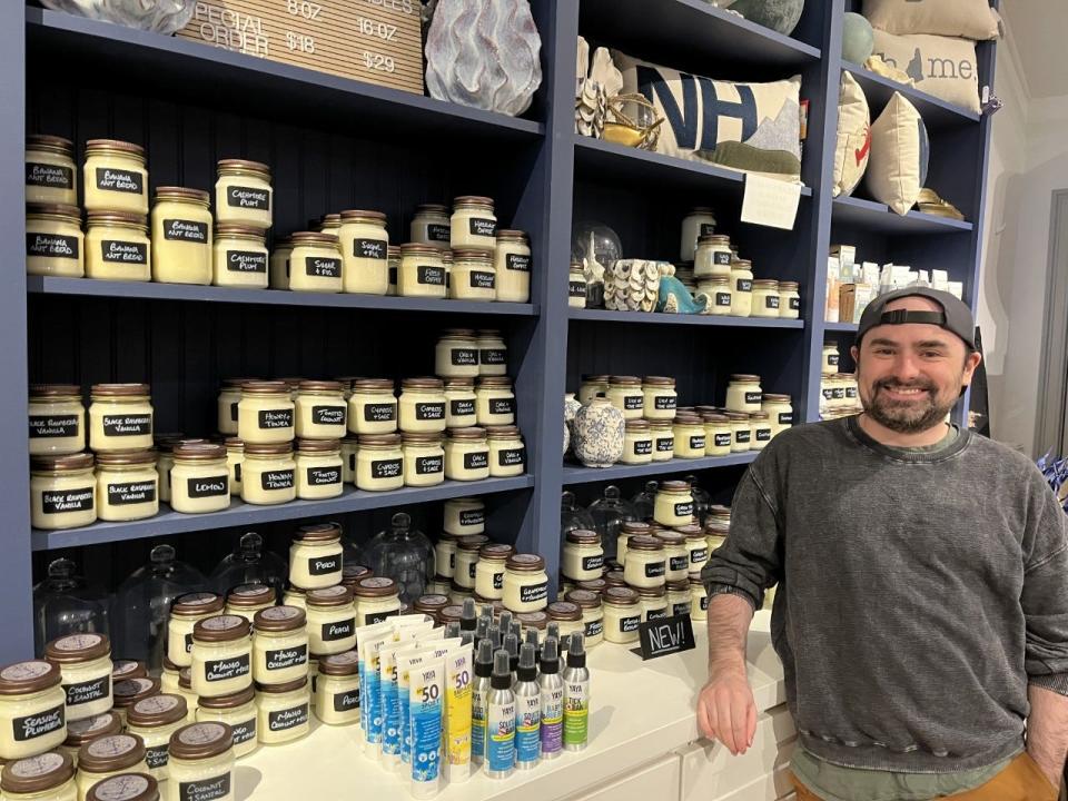 Kyle Eldridge, owner of Crafted New England in Exeter, New Hampshire, sees an economy that is not working for working people. In this file photo, he is pictured by his line of handcrafted soy candles.