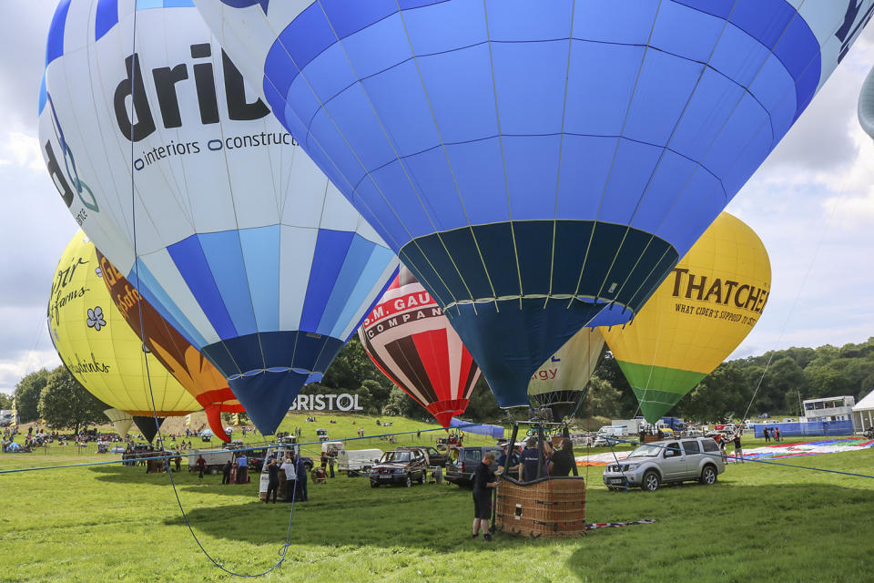 <p>Hot air Balloons are being tethered as balloonists prepare to launch at the Bristol international balloon fiesta held on August 10, 2017 in Avon, England. (Photo: Amer Ghazzal/Barcroft Images) </p>