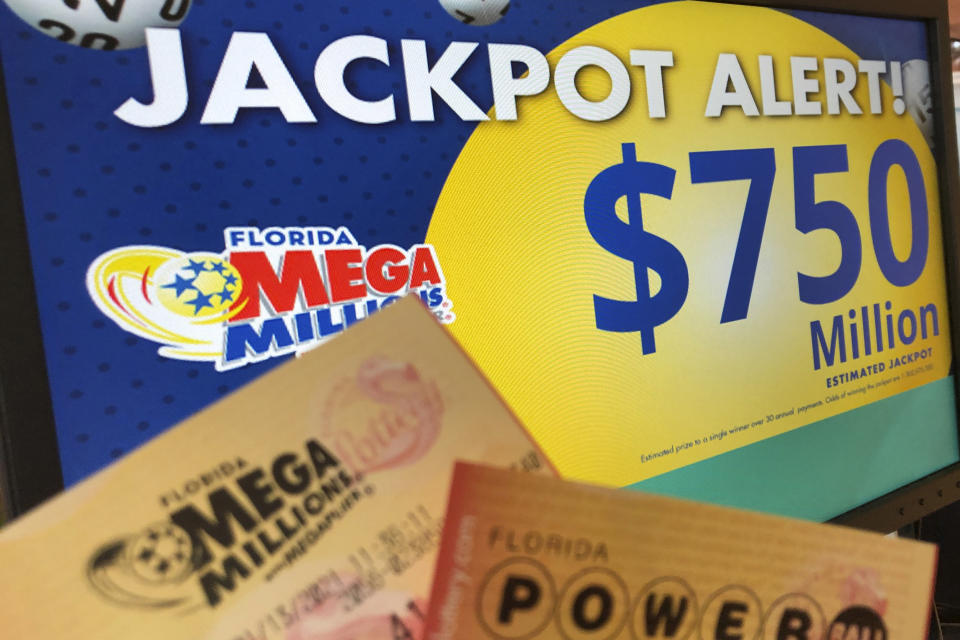 Powerball and Mega Millions lottery tickets are shown at a retailer, Wednesday, Jan. 13, 2021, in Surfside, Fla. Lottery players will have a shot Friday night at the fifth-largest jackpot in U.S. history after no tickets matched all the numbers in the latest Mega Millions drawing. The big prize for Powerball, the other national lottery game, is $550 million for Wednesday night's drawing. (AP Photo/Wilfredo Lee)