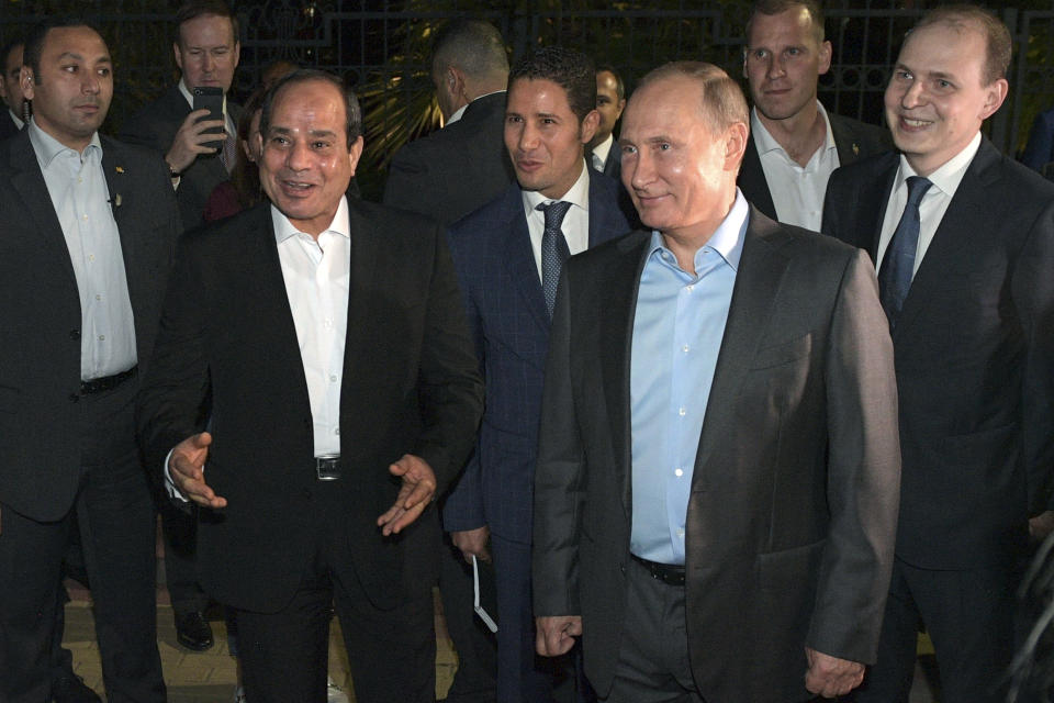 Russian President Vladimir Putin, foreground right, and Egyptian President Abdel-Fattah el-Sisi, foreground left, talk with local people during their meeting on embankment of the Olympic Park in the Black Sea resort of Sochi, Russia, Tuesday, Oct. 16, 2018. Egypt's president urged Russia on Tuesday to resume direct flights to Egyptian resorts as he discussed ways to bolster ties with Russian officials and lawmakers. (Alexei Druzhinin, Sputnik, Kremlin Pool Photo via AP)