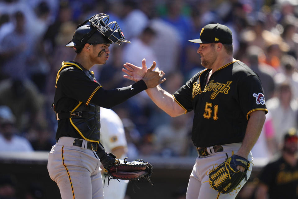 Pittsburgh Pirates relief pitcher David Bednar (51) celebrates with teammate catcher Endy Rodriguez after the Pirates defeated the San Diego Padres 3-2 in a baseball game Wednesday, July 26, 2023, in San Diego. (AP Photo/Gregory Bull)