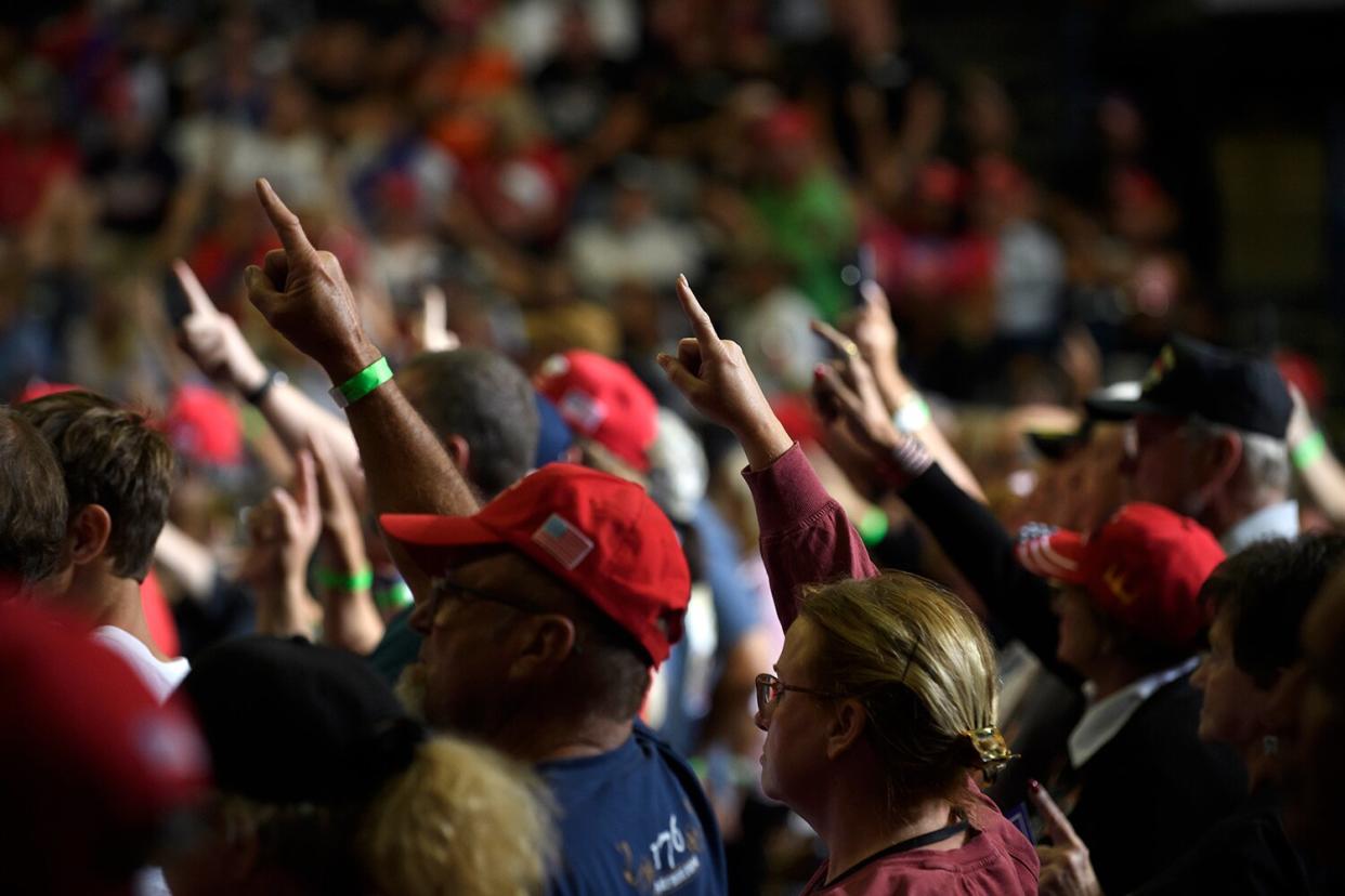 Audience members put their index finger up to symbolize America First while President Donald Trump speaks at a Save America Rally to support Republican candidates running for state and federal offices in the state of Ohio at the Covelli Centre on September 17, 2022 in Youngstown, Ohio.