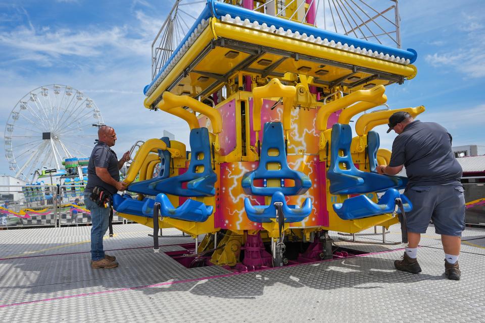 Ron Dean, left, and Jon Kaufman, inspectors for the Ohio Department of Agriculture, examine the Mega Drop amusement ride at the Ohio State Fair on Monday. The fair runs from July 27 to Aug. 7.