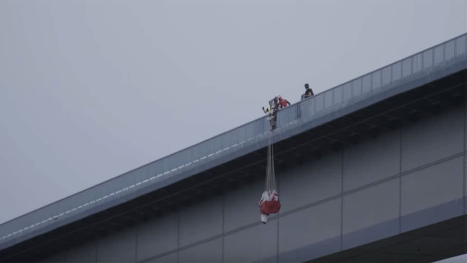 McDougall can be seen from a distance talking to the oblivious base jumper who was about to jump to his death. Photo: YouTube