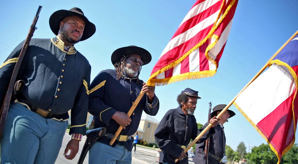 Buffalo soldier reenactors lead a Juneteenth parade down Martin Luther King Drive on Saturday, June 19, 2021.