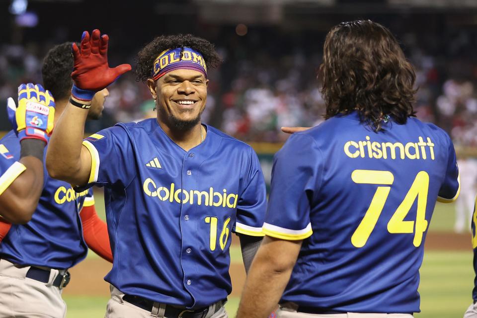 PHOENIX, ARIZONA - MARCH 11: Reynaldo Rodriguez #16 of Team Colombia celebrates with Nabil Crismatt #74 after hitting a two-run home run against Team Mexico during the fifth inning of the World Baseball Classic Pool C game at Chase Field on March 11, 2023 in Phoenix, Arizona. (Photo by Christian Petersen/Getty Images)