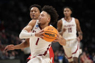 Alabama guard Mark Sears (1) starts his drive for a layup past Maryland guard Jahmir Young during the second half of a second-round college basketball game in the men's NCAA Tournament in Birmingham, Ala., Saturday, March 18, 2023. (AP Photo/Rogelio V. Solis)