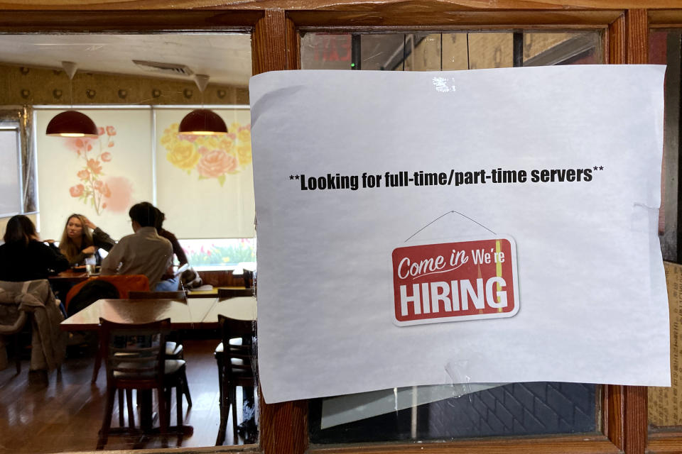 A hiring sign is displayed at a restaurant in Morton Grove, Ill., Thursday, April 28, 2022. America’s employers added 428,000 jobs in April, extending a streak of solid hiring that has defied punishing inflation, chronic supply shortages, the Russian war against Ukraine and much higher borrowing costs. (AP Photo/Nam Y. Huh)