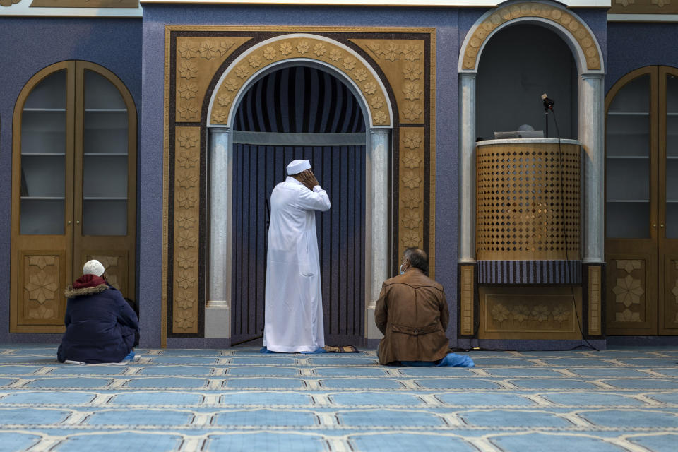 Muslims who live in Greece pray inside the first state-funded mosque in Athens on Friday, Nov. 6, 2020. Friday prayers have been held for the first time in the Greek capital's first state-sponsored mosque, which opened this week after years-long delays. The project to build a mosque in Athens has taken about 14 years and was dogged by protests, political controversy and delays in this heavily Christian Orthodox country. (AP Photo/Petros Giannakouris)