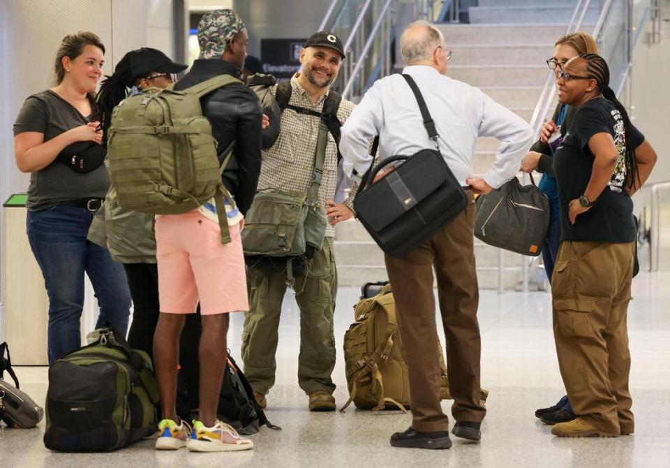 Passengers smile after being greeted in the Arrivals area after arriving on the first evacuation flight out of Cap-Haitien, Haiti, and arriving at Miami International Airport after the suspension of flights nearly two ago after some Haitian-Americans evacuated and returned to the United States on Sunday, March 17, 2024.