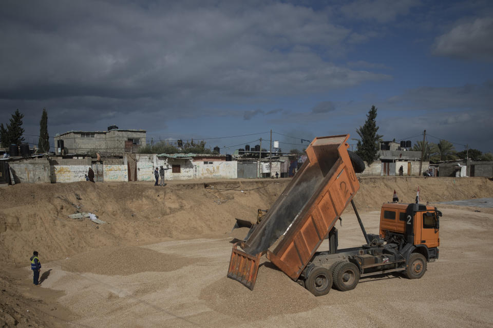 Laborers work on concrete slab foundations for one of three Egyptian-funded housing complexes in the Gaza Strip, in the town of Beit Lahiya, northern Gaza, Thursday, Jan. 20, 2022. After years of working behind the scenes as a mediator, Egypt is taking on a much larger and more public role in Gaza. In the months since it brokered a Gaza cease-fire last May, Egypt has sent crews to clear rubbled and promised to build vast new apartment complexes, and billboards of its president Abdel-Fattah el-Sissi, are a common sight. (AP Photo/Khalil Hamra)