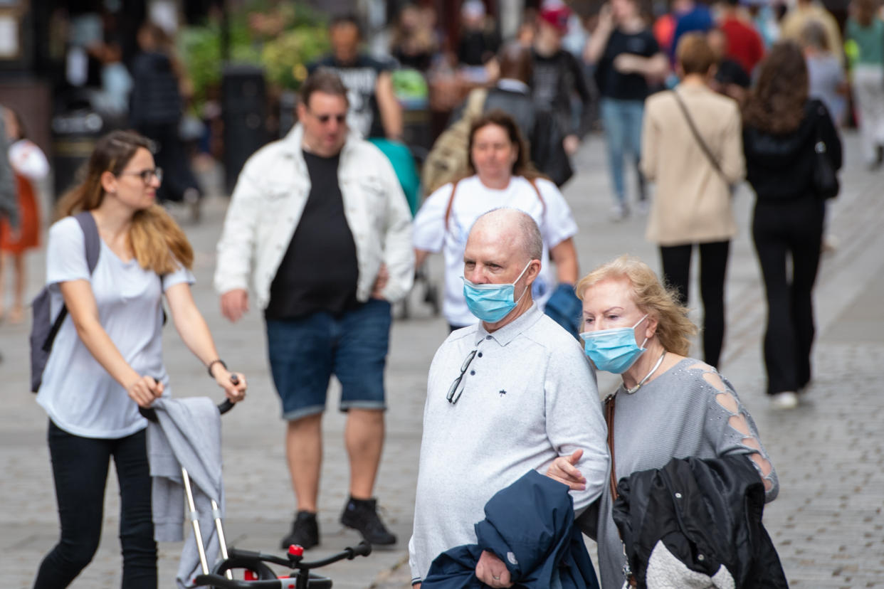 People wearing face masks watch a street entertainer in Covent Garden, London. Rumours were abound in the Sunday newspapers that Prime Minister Boris Johnson, who is due to update the nation this week on plans for unlocking, is due to scrap social distancing and mask-wearing requirements on so-called 