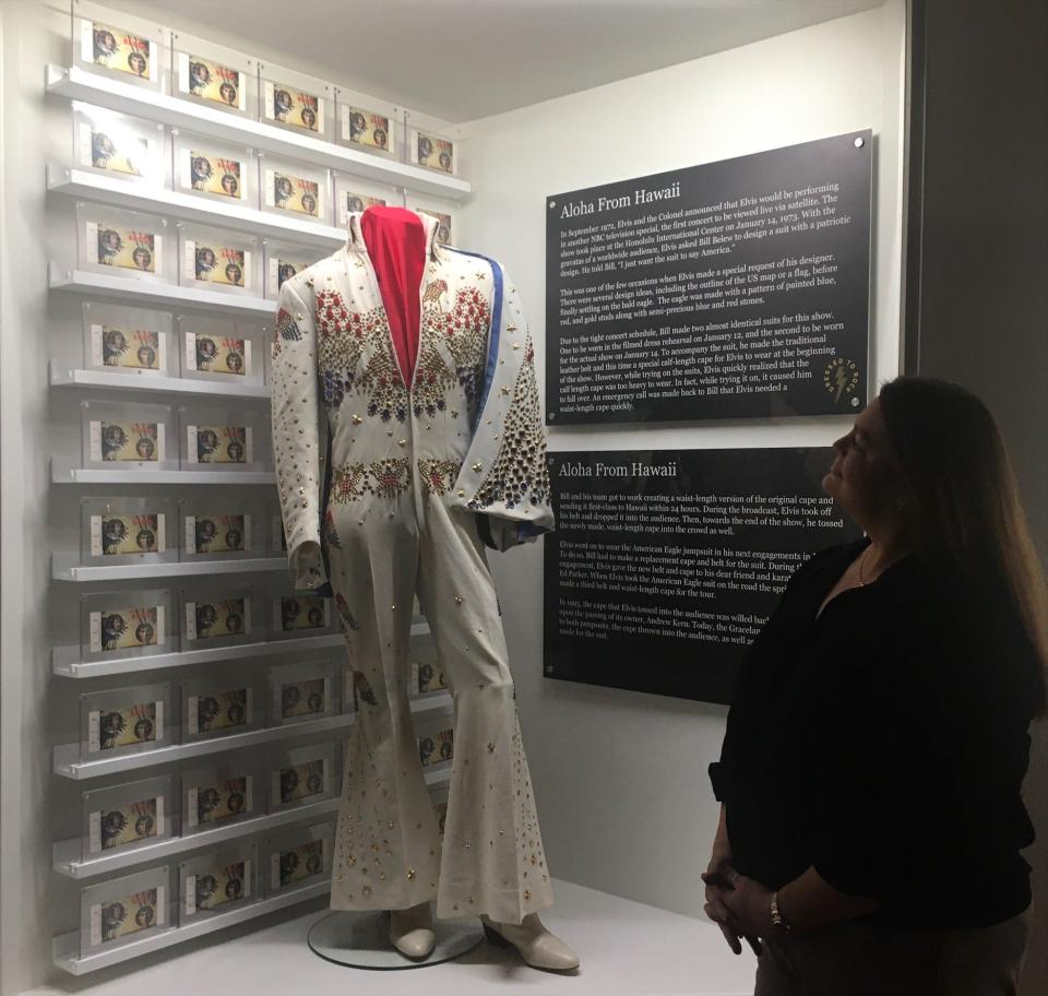 Graceland archivist Angie Marchese with the "Aloha from Hawaii" jumpsuit, which is part of the "Elvis: Dressed to Rock" exhibit at Elvis Presley's Memphis. The exhibit features more than 100 jumpsuits, tunics, capes, belts, pieces of jewelry and pairs of sunglasses worn by the King of Rock 'n' Roll from 1969 to 1977.