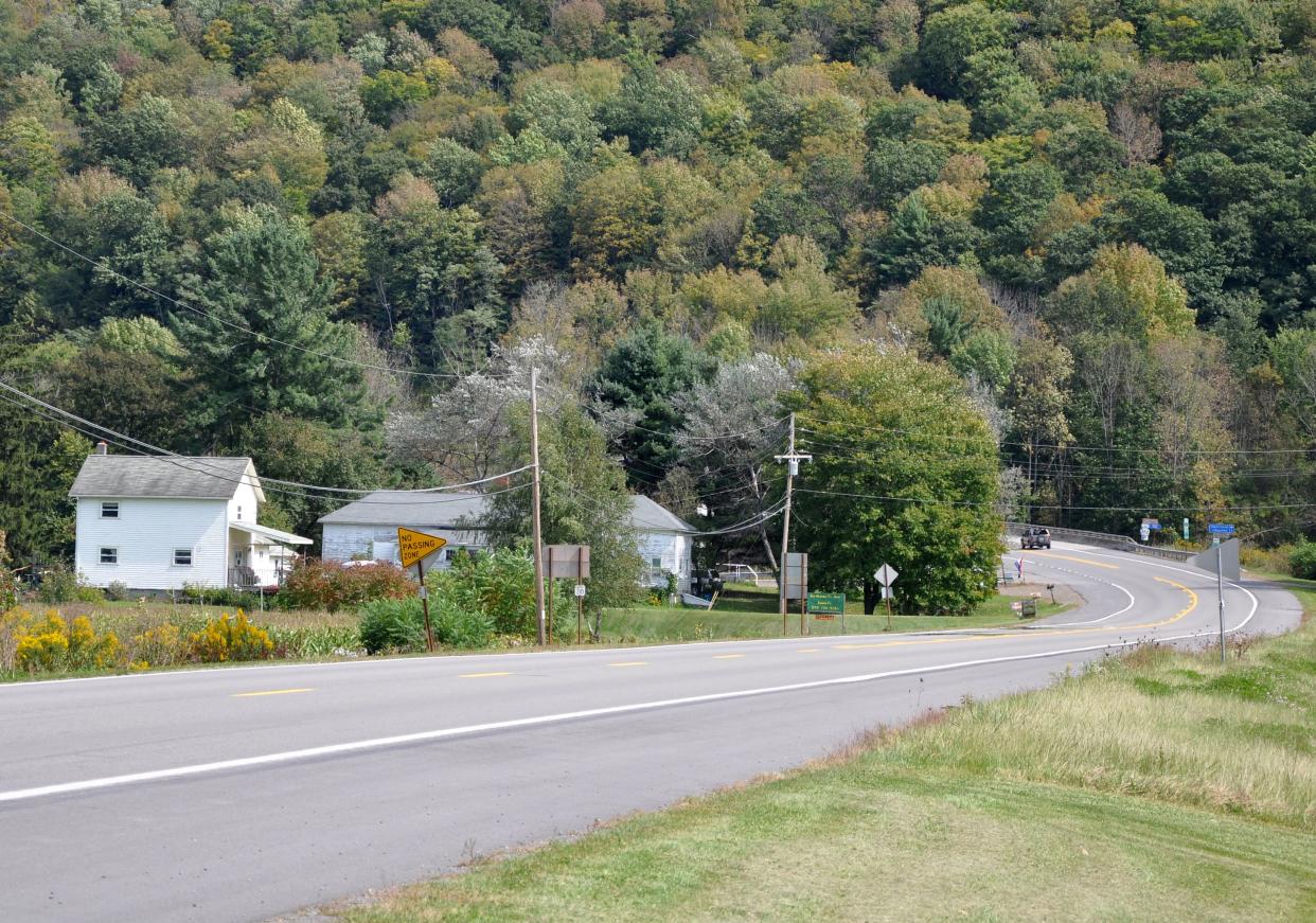 U.S. Route 6 in Ansonia, Pennsylvania, with rural homes and forest in the background