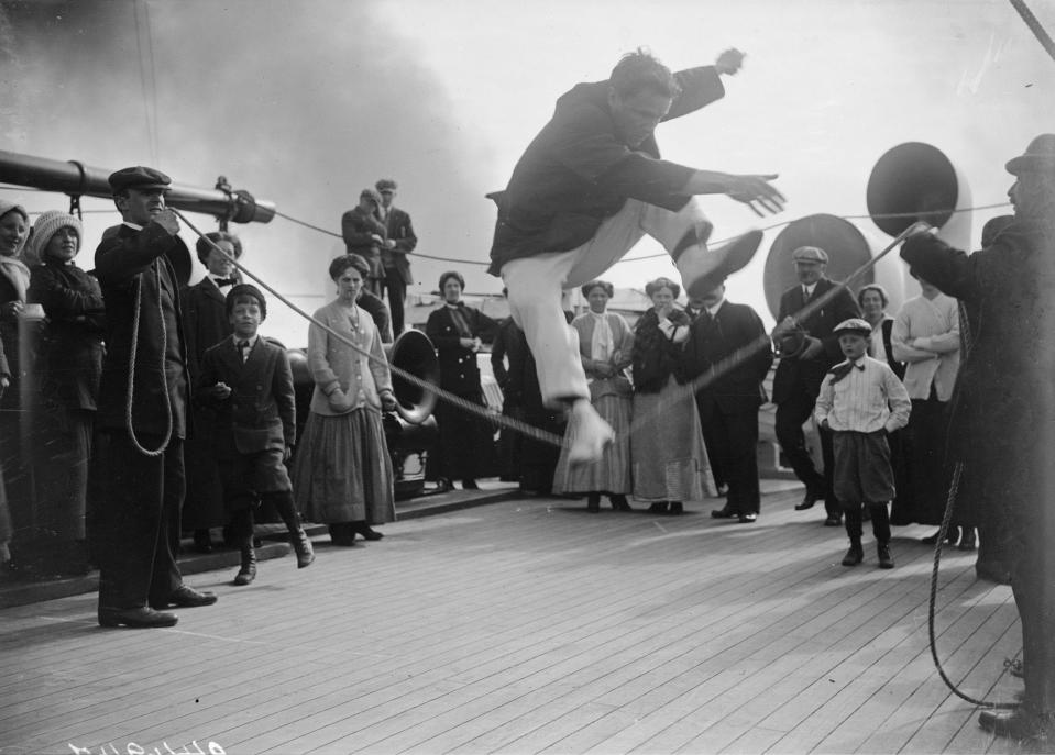 Passengers compete in a high jump contest on the deck of Franconia.
