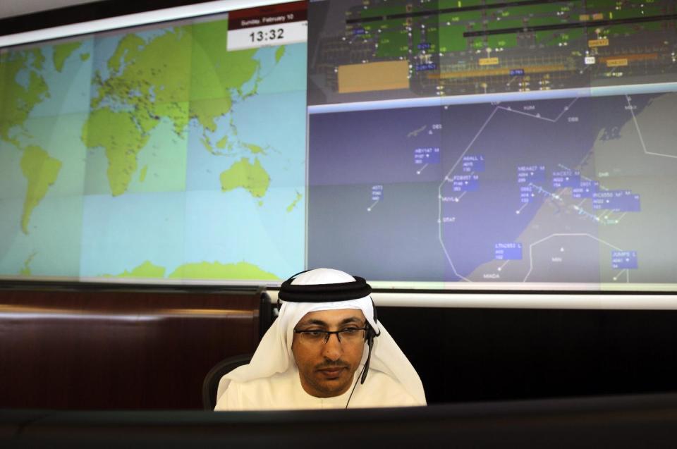 In this Sunday, Feb. 10, 2013, photo. an Emirati technician works at the Emirates Network Control Center in Dubai, United Arab Emirates. For generations, international fliers have stopped over in London, Paris and Amsterdam. Now, they increasingly switch planes in Dubai, Doha and Abu Dhabi, making this region the new crossroads of global travel. The switch is driven by both the airports and airlines, all backed by governments that see aviation as the way to make their countries bigger players in the global economy. (AP Photo/Kamran Jebreili)