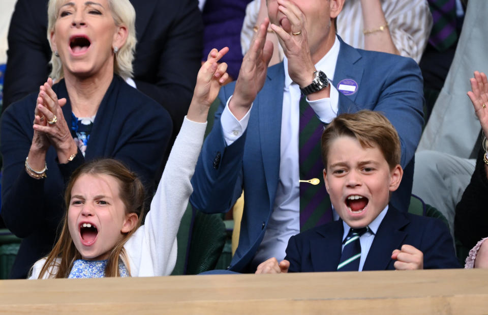 Charlotte with her hand raised and George with fist pumps