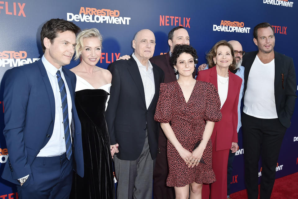 Reassuring hands: Portia de Rossi holds Jeffrey Tambor’s hand and Tony Hale rests his hand on his co-star’s shoulder at the premiere of Netflix’s <em>Arrested Development</em> Season 5 on May 17. (Photo: Gabriel Olsen/WireImage)