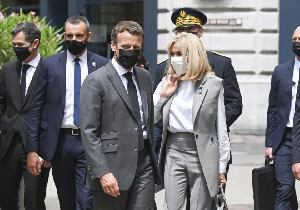 French President Emmanuel Macron and his wife Brigitte arrive for a lunch Tuesday June 8, 2021 in Valence, southeastern France. French President Emmanuel Macron has been slapped in the face by a man during a visit in a small town of southeastern France, Macron's office confirmed. (Philippe Desmazes, Pool via AP)