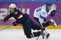 T. J. Oshie of the United States falls to the ice after battling Sakari Salminen of Finland during the first period of the men's bronze medal ice hockey game at the 2014 Winter Olympics, Saturday, Feb. 22, 2014, in Sochi, Russia. (AP Photo/Matt Slocum)