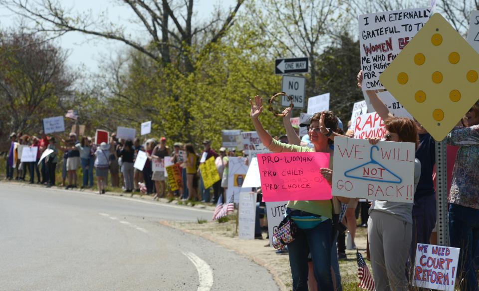 Demonstrators stand along the edge of the Orleans Rotary on May 14 in support of abortion rights as part as a nationwide protest over leaked Supreme Court documents suggesting an overturn of Roe v. Wade, which was officially overturned this week.