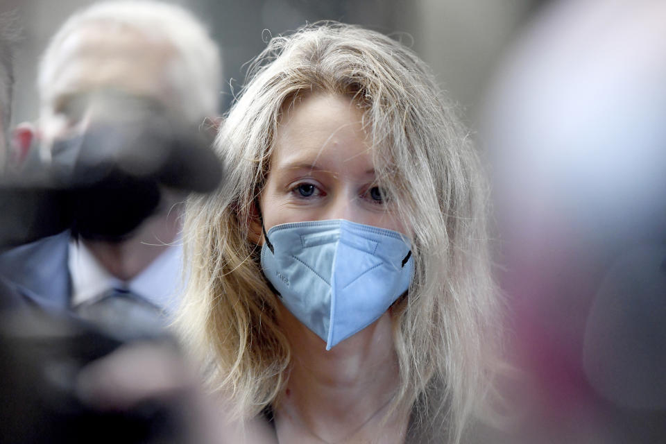 FILE - Elizabeth Holmes, founder and CEO of Theranos, arrives at the federal courthouse for jury selection in her trial, Tuesday, Aug. 31, 2021, in San Jose, Calif. Coming into 2022, Holmes, once worth $4.5 billion on paper, is now awaiting a jury's verdict on fraud charges that she misled investors and patients about the accuracy of a blood-testing technology developed at her startup Theranos. (AP Photo/Nic Coury, File)