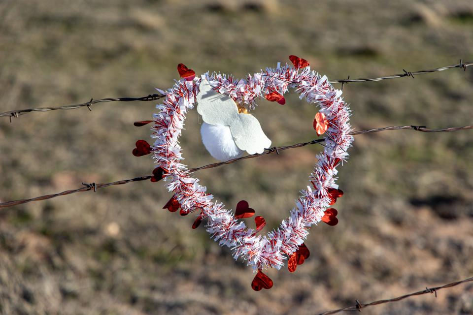 A heart is hung from barbed wire near where the body of 4-year-old Athena Brownfield was found near Rush Springs, Okla. on Wednesday, Jan. 19, 2023.