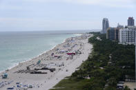 Beach chairs and umbrellas line the beach, Monday, Nov. 15, 2021, in Miami Beach, Fla. As the tourism industry struggles to bounce back from COVID-19, and eager but tentative travelers resume plans, Miami is one of the top search destinations on several travel websites. (AP Photo/Lynne Sladky)