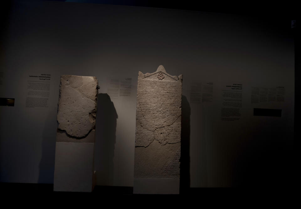 The Heliodorus Stele, center, loaned by American billionaire Michael Steinhardt, is displayed at the Israel Museum in Jerusalem, Wednesday, Jan. 5, 2022. Last month, Steinhardt surrendered the artifact, along with 179 others valued at roughly $70 million, as part of a landmark deal with the Manhattan District Attorney's office to avoid prosecution. Eight Neolithic masks loaned by Steinhardt to the Israel Museum for a major exhibition in 2014 were also seized as part of the billionaire's deal with New York authorities. (AP Photo/Maya Alleruzzo)
