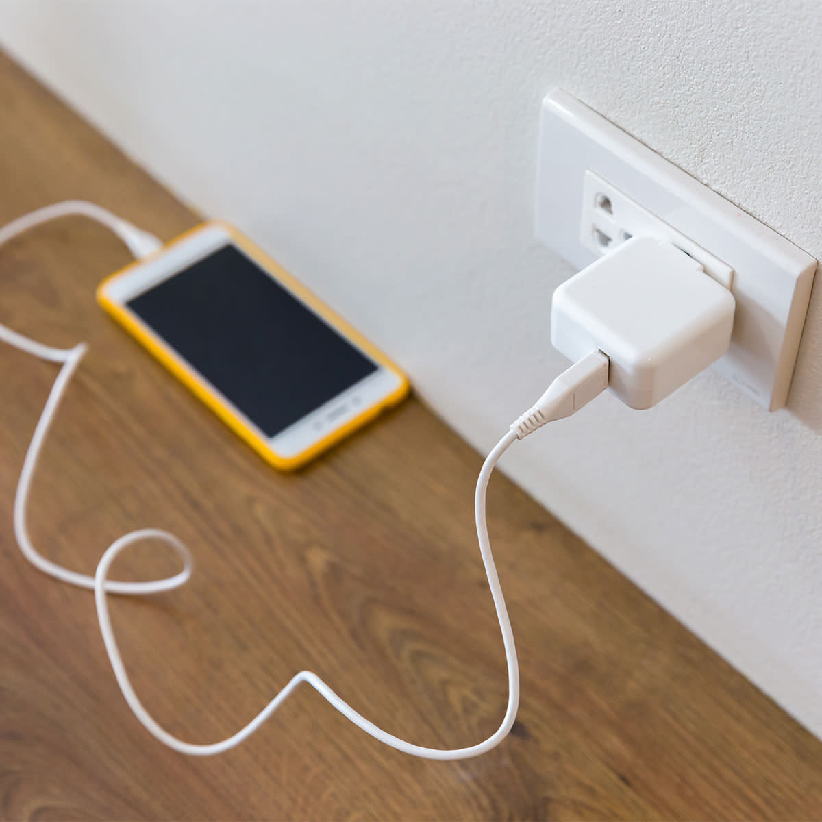 white-iphone-charging-wall-socket